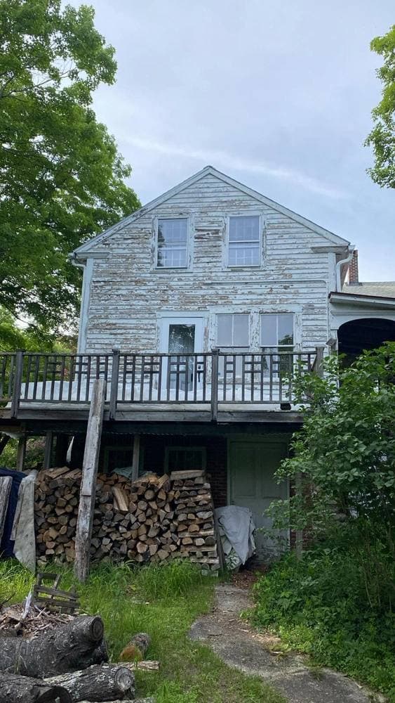 A historic colonial home with painted trim on a tree-lined street in Cambridge, Massachusetts